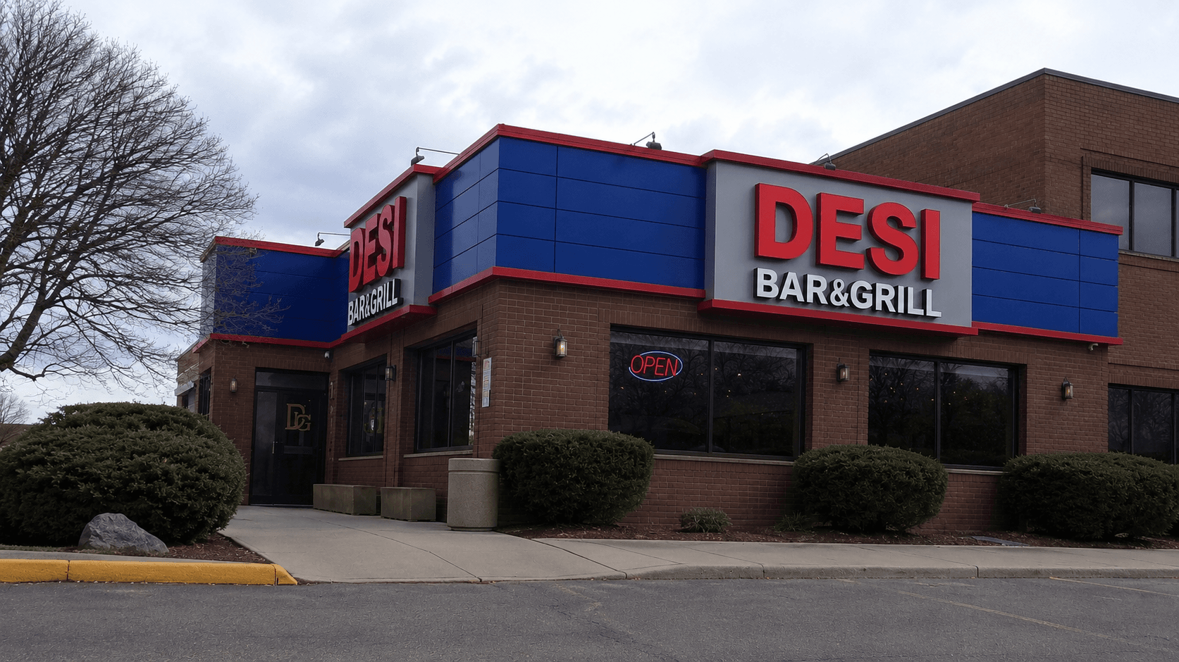 Desi Bar & Grill storefront with blue and red ACM cladding and channel letter signage