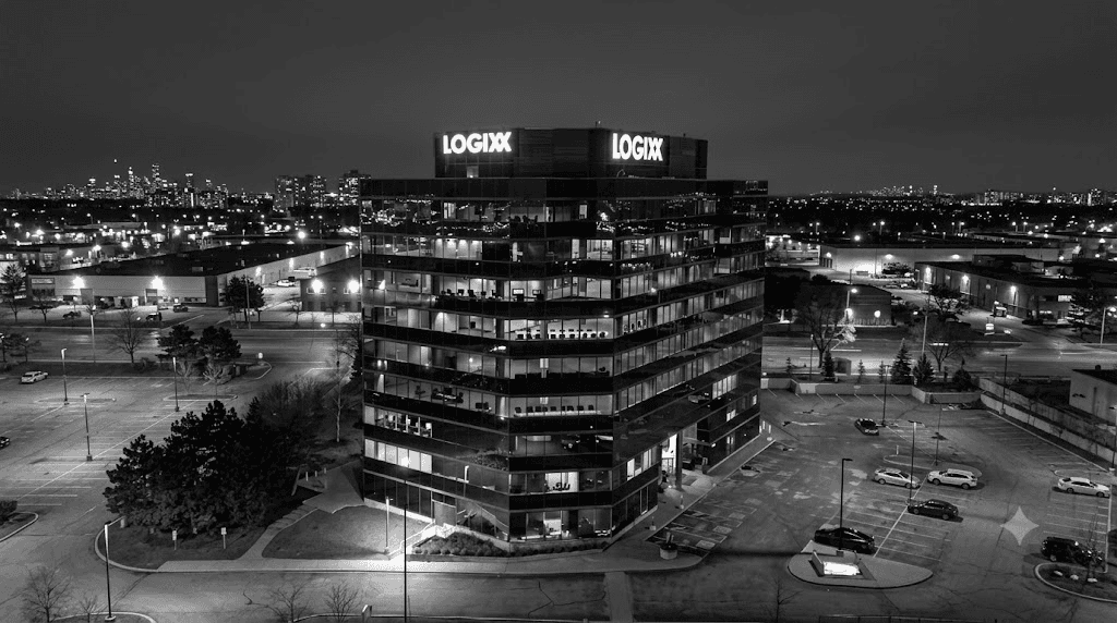 Logixx illuminated rooftop building signage on an office tower at night