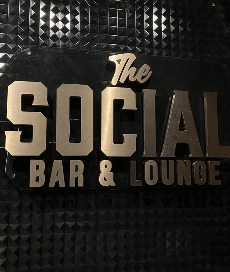 Brushed gold dimensional lettering reading The Social Bar & Lounge